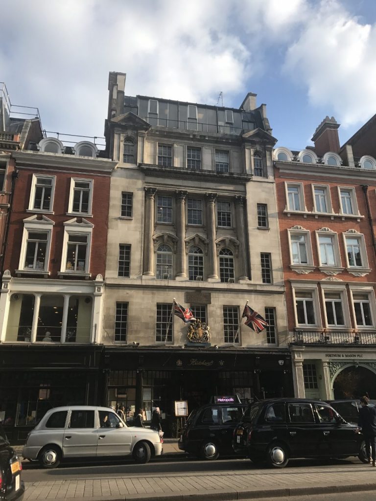 An old, brown, partially-brick building with lots of small windows